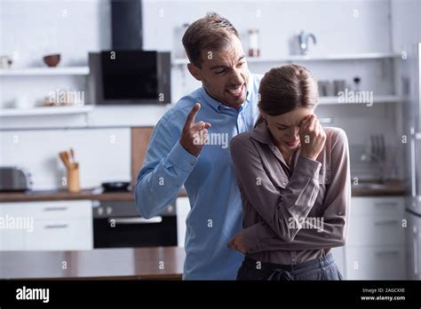 Aggressive Man In Shirt Screaming At Crying Wife During Quarrel Stock
