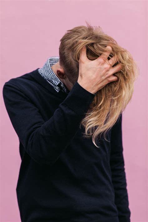 stock photo  young man  blonde hair hiding face   images