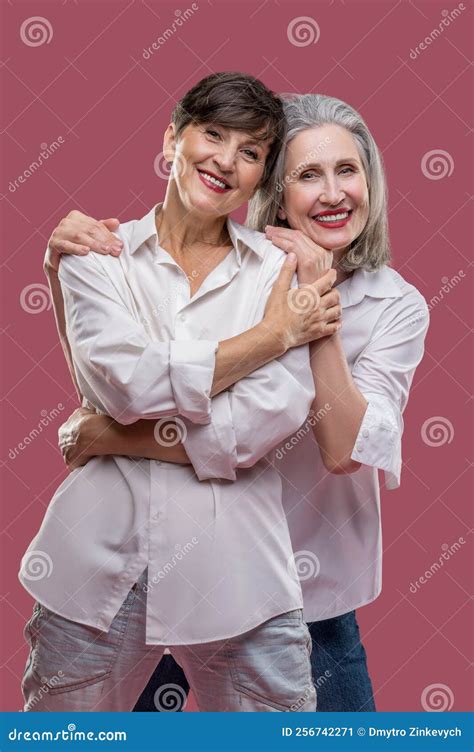 Two Cute Mature Women Standing Together And Hugging Stock Image Image