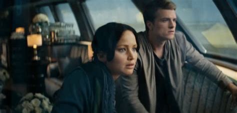 katniss goes to war in a new hunger games catching fire trailer
