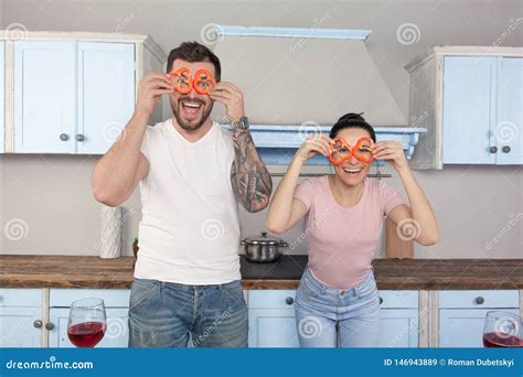 Young Beautiful Couple Fool In The Kitchen They Keep Bits Of Bulgarian