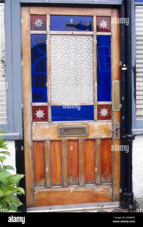 Close Up Of Front Door With Blue And Red Victorian Stained Glass Stock