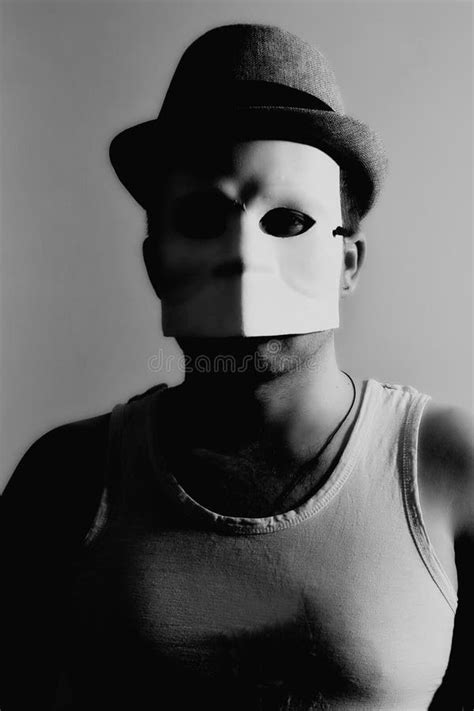 man wearing white masquerade mask stock photo image  black business