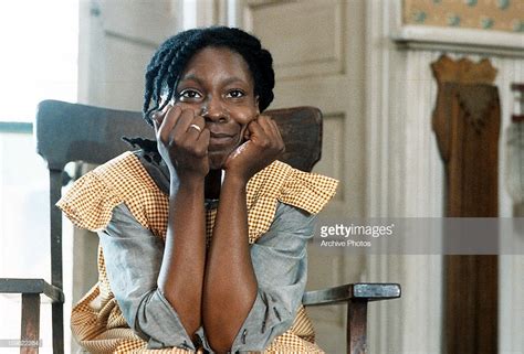 Whoopi Goldberg Sitting In A Chair With Her Hands On Her