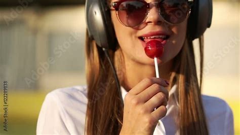 Stock Video Of Young Attractive Girl Listening To Music On Headphones
