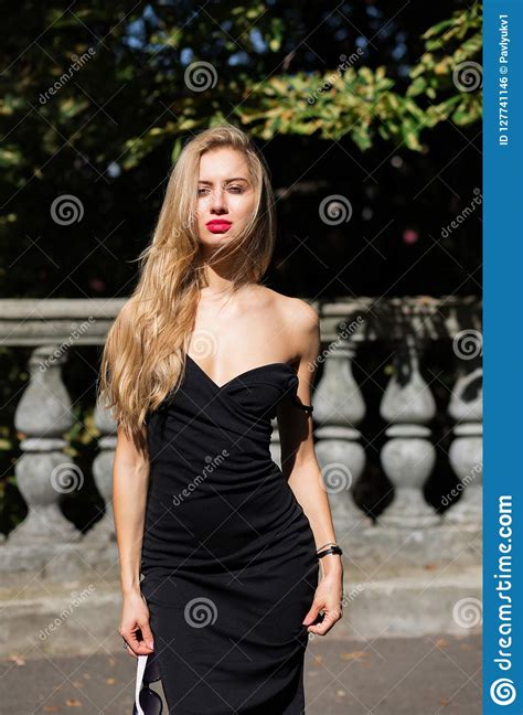 outdoor shot of blonde model with lush hair wearing black