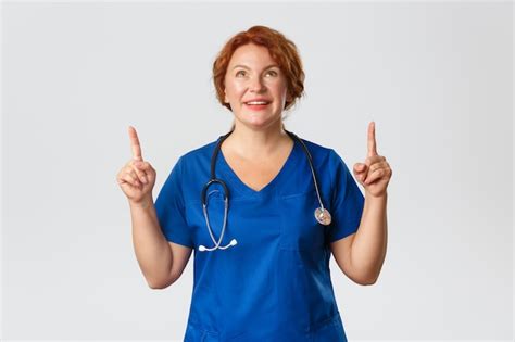 Premium Photo Dreamy Smiling Middle Aged Redhead Doctor Female Nurse