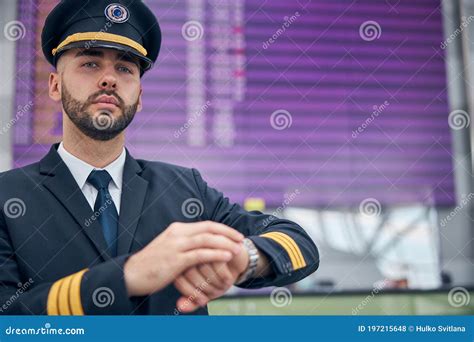 handsome male pilot standing  airport terminal stock photo image