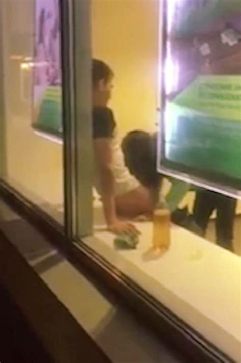 woman performs sex act on man in full view of passersby from bank