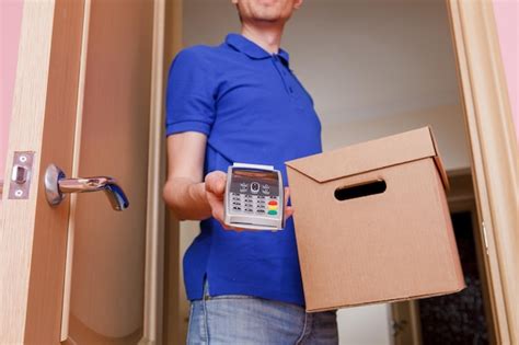 Premium Photo Courier Man In Blue Tshirt And Baseball Cap With Pin