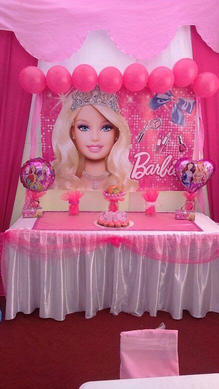 a barbie birthday party with pink balloons and decorations