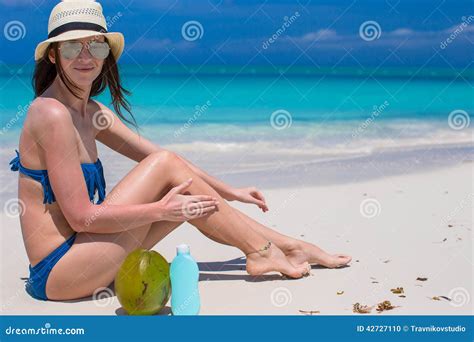young woman apply cream   smooth tanned legs stock photo image  lotion shore