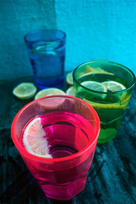 Sparkling Water Soda Or A Gin And Tonic In Colorful Glasses With Lemon