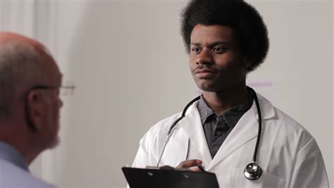 african american male doctor with patient stock footage