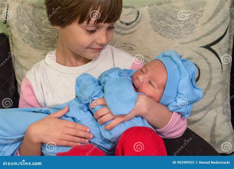 big sister holding her newborn brother stock image image of hand
