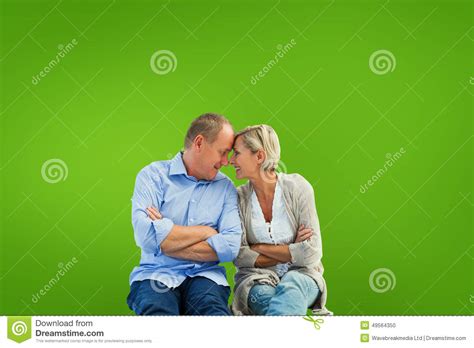 Composite Image Of Happy Mature Couple Smiling At Each Other Stock