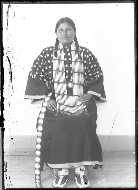 Portrait Of A Native American Woman Standing By A Wall