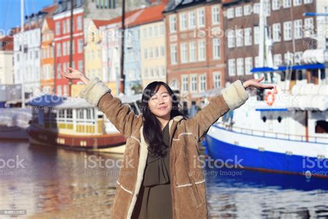 happy japanese woman on holiday standing with arms spread open in