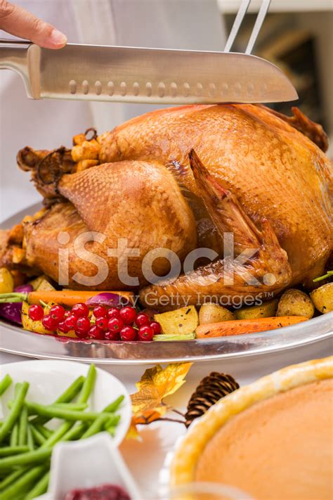 young father carving thanksgiving turkey   family stock photo royalty  freeimages