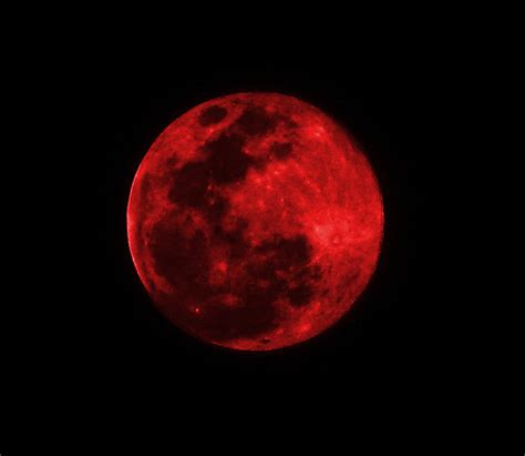 Red Moon Suspended In Space Assailed Impaled By