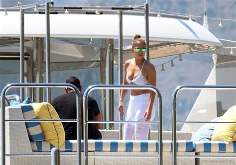 jennifer lopez relaxing in white bikini top and tight pants during