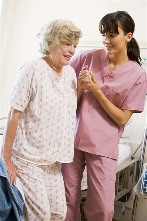 nurse helping senior woman  walk cna classes