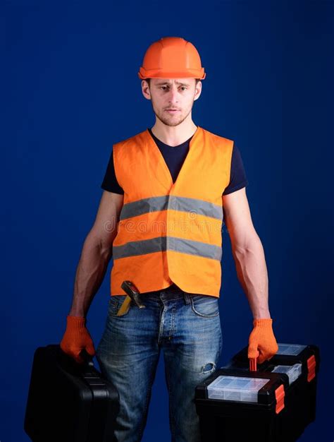 professional repairman concept worker handyman repairman builder  strict face carries bags