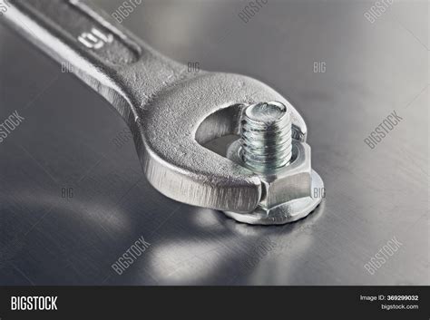 wrench tightens bolt image photo  trial bigstock