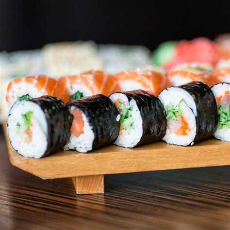 sushi rolls served   wooden plate ghost influence