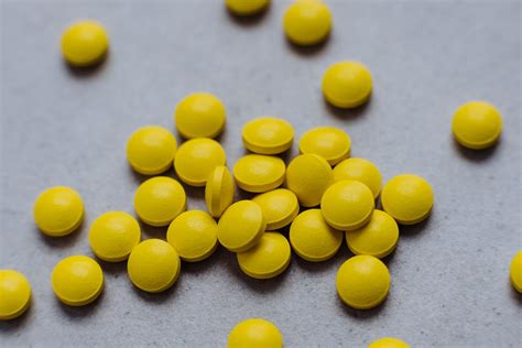 yellow  medication pill  gray textile  stock photo