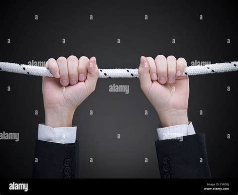 close    businessmans hands hanging   rope stock photo alamy