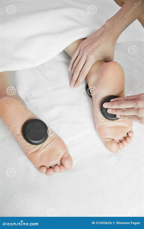 woman receiving hot stone foot massage royalty  stock image image