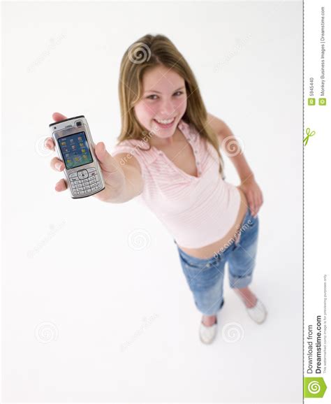 teenage girl holding  cellular phone  smiling stock photo image