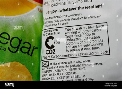 carbon emissions label showing carbon footprint  walkers alt  vinegar crisp packet uk stock