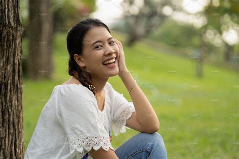 happy asian woman in the garden containing asian female and happy