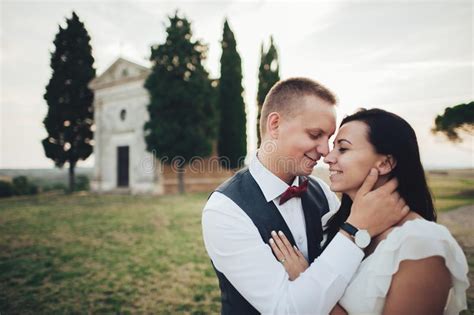 happy stylish smiling couple walking in tuscany italy on their stock