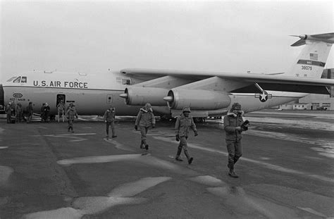 army troops exit   air force   starlifter aircraft   stopover  en route