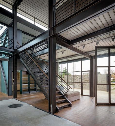 contemporary industrial house features  expressive interior  raw steel steel building