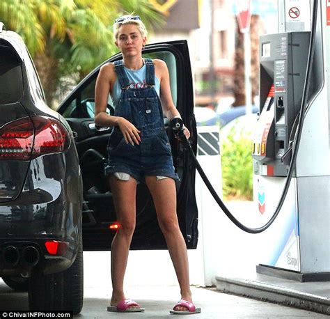 Miley Cyrus Picks Dollar Bills Off The Floor While Filling Up Her