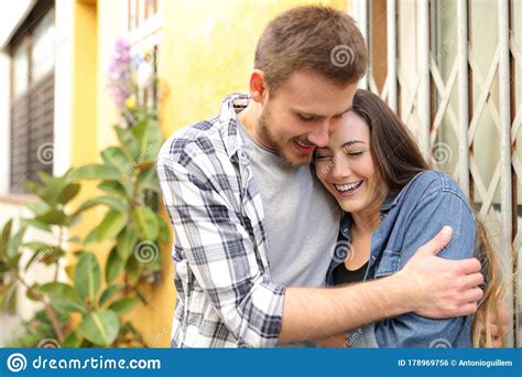 Couple In Love Flirting And Hugging In The Street Stock