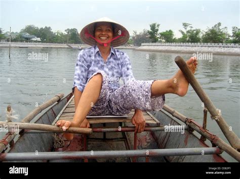 Vietnamese Woman Rowing With Her Feet On The Ngo Dong River Tam Coc