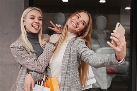 premium photo cheerful girlfriends taking selfie after shopping
