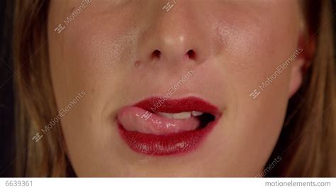 close up slow motion female licks her red lips stock video footage