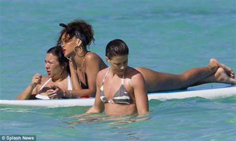 rihanna bares her body in a g string bikini while sunbathing on a