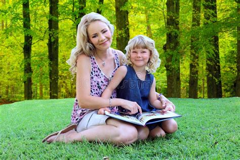 lovely mom and daughter reading outdoors stock image image of