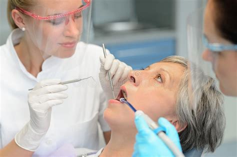 dental team checkup elderly patient woman teeth stock