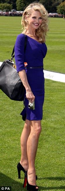 christie brinkley draws attention to her tiny waist in a tight blue dress at the cartier polo