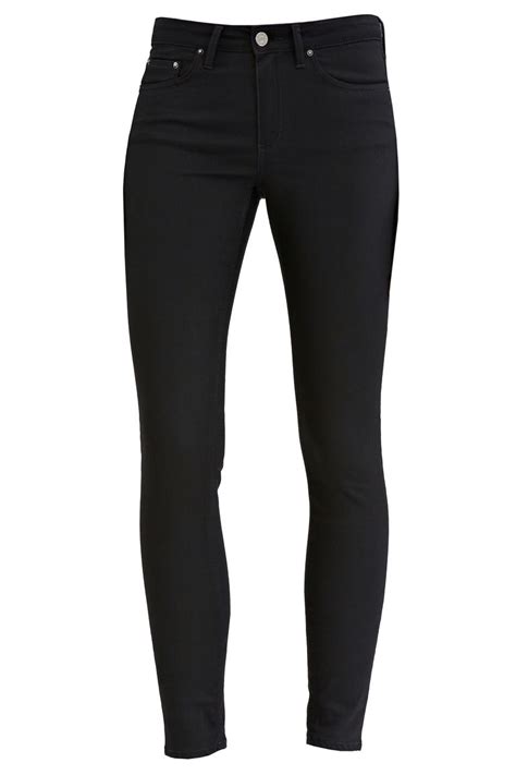 best black jeans according to elle editors flared and skinny black