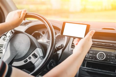 woman driving while holding a mobile in horizontal