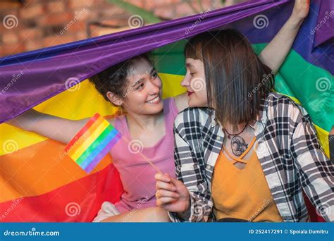 Very Romantic Lesbian Couple On The Sofa Hugging Each Other And Holding